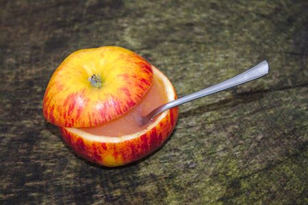 Apple sauce on an apple on a tree trunk