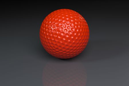 Red golfball on gray slightly reflective backgroundの写真素材