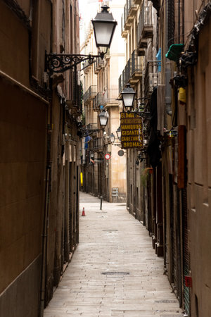 View of a narrow street in the city of Barcelona, Spain.の写真素材