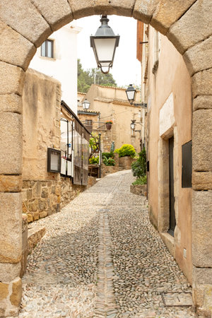 Narrow street in the old town of Tossa de Mar, Spain.の写真素材