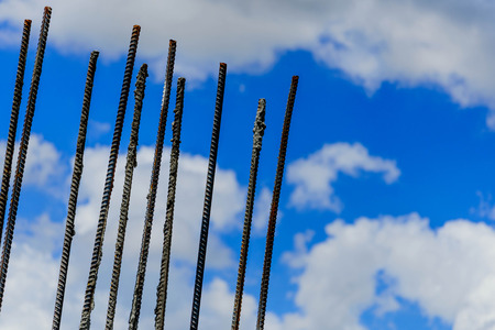 rebar protruding against a cloudy skyの写真素材