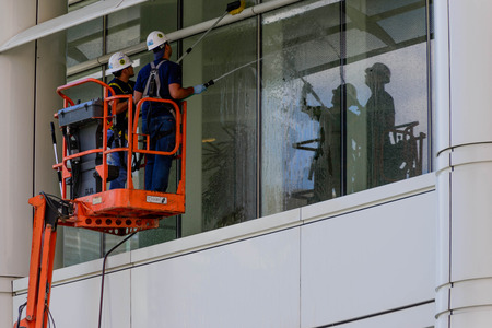 window washing workers on skyjackのeditorial素材