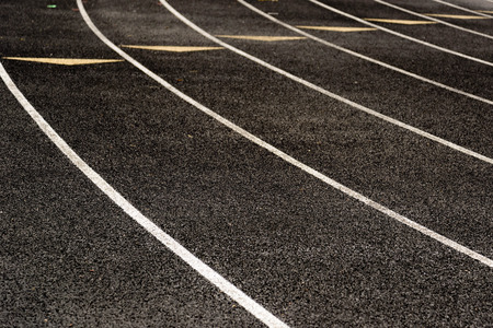outdoor black running track with painted lane linesの写真素材