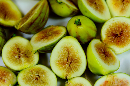 sliced green ripe figs ready to eatの写真素材