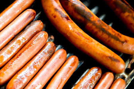 hotdogs cooking on the outdoor barbeque grillの写真素材