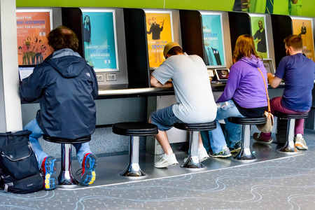 DIA, DEN, Denver International Airport, CO - people using a laptop charging station at an airportのeditorial素材