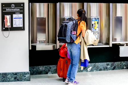IAH, Houston Intercontinental Airport, Houston, TX, USA - Passengers walking with luggage in an airportのeditorial素材