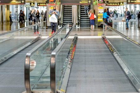 DIA, DEN, Denver International Airport, CO - Daylighting roof structure with people walking and people movers in an airportのeditorial素材