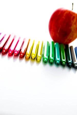 bright colored back to school supplies and an apple for the teacherの写真素材