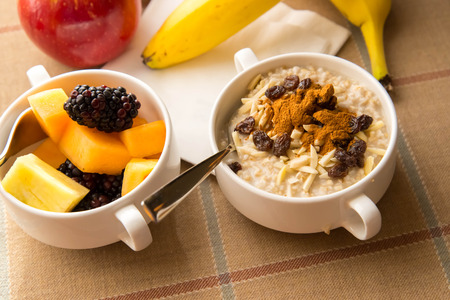Fresh fruit and oatmeal with nuts and fruit toppings for breakfastの写真素材