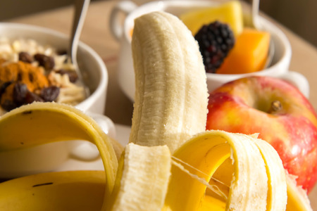 Fresh fruit and oatmeal with nuts and fruit toppings for breakfastの写真素材