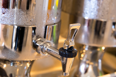 stainless steel iced water dispenser with condensationの写真素材