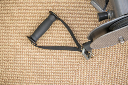 Indoor exercise equipment - hand grips close-up on textured floor