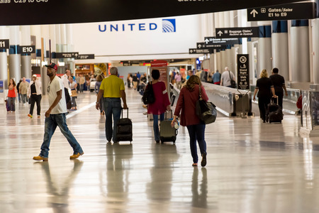 IAH, Houston Intercontinental Airport, Houston, TX, USA - passengers walking with lugagge in airportのeditorial素材