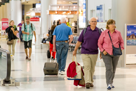 IAH, Houston Intercontinental Airport, Houston, TX, USA - passengers walking with lugagge in airportのeditorial素材