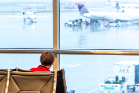 IAH, Houston Intercontinental Airport, Houston, TX, USA - passengers sitting with lugagge in airportのeditorial素材