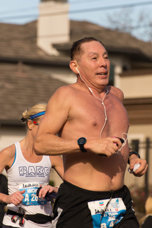 January 18, 2015 - Houston, TX, USA: Houston 2015 Marathon runners on Memorial Drive after passing mile 22のeditorial素材