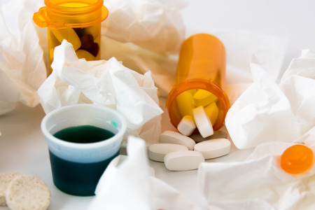 cold and flu season medicines for cough, sneeze, and sore throatの写真素材