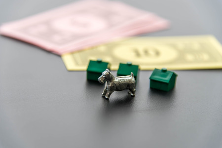 February 8, 2015 - Houston, TX, USA.  Monopoly money, dog and green housesのeditorial素材