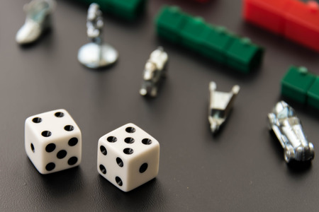 February 8, 2015 - Houston, TX, USA.  Monopoly money, and playing pieces in rowsのeditorial素材