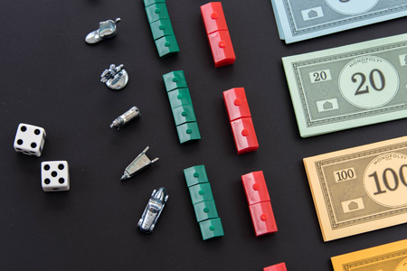 February 8, 2015 - Houston, TX, USA.  Monopoly money, and playing pieces in rowsのeditorial素材