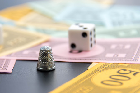 February 8, 2015 - Houston, TX, USA.  Monopoly thimble, dice and moneyのeditorial素材