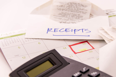 Tax preparation supplies and a calendar with a red box around tax day, April 15の写真素材