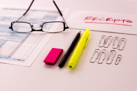 Tax preparation supplies, reading glasses and blank tax formsの写真素材