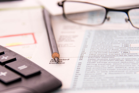 Tax preparation supplies, reading glasses and blank tax formsの写真素材