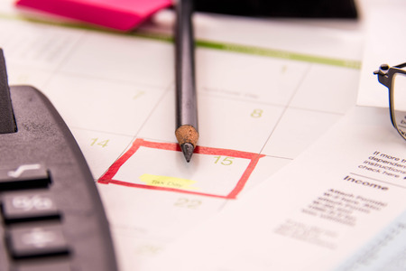 Tax preparation supplies, reading glasses and blank tax formsの写真素材