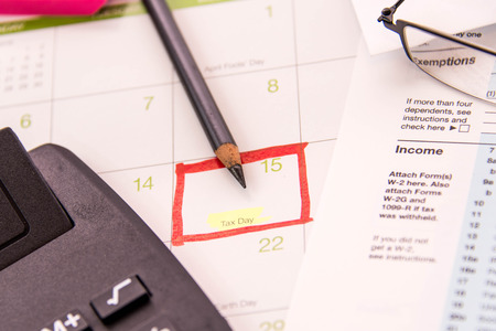 Tax preparation supplies, reading glasses and blank tax formsの写真素材