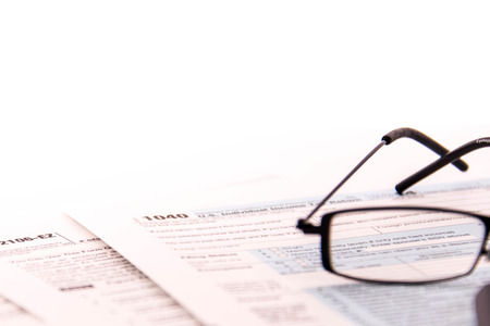 Tax preparation supplies, reading glasses and blank tax forms
