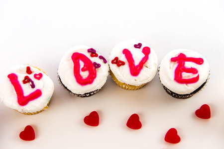Valentines Day cupcakes with frosting letters spelling LOVEの写真素材