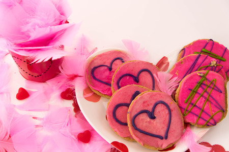 Valentines Day decorations and cookies with pink frosting and heartsの写真素材