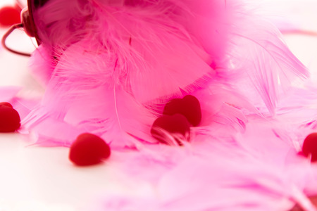 Valentines Day decorations, pink feathers and heart shaped candiesの写真素材
