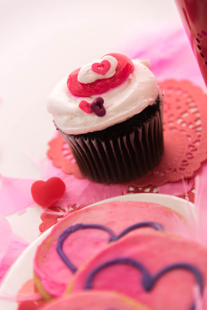 Valentines Day decorations, pink cookies and cupcakes with heartsの写真素材