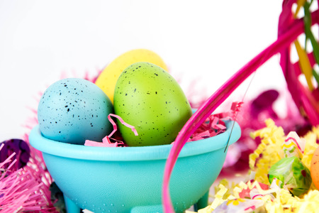 colored Easter eggs, marshmallow chicks, candy and  basket