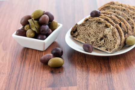 fresh baked olive bread and olivesの写真素材