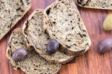 fresh baked olive bread and olivesの写真素材