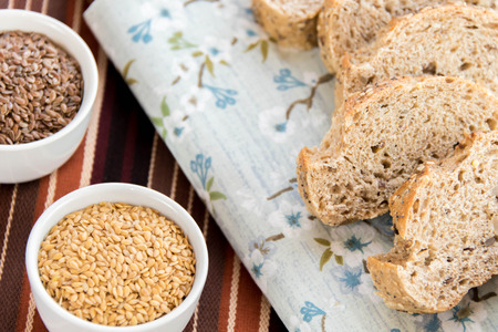 a fresh baked loaf of whole grains bread with poppy, flax adn sunflower seedsの写真素材