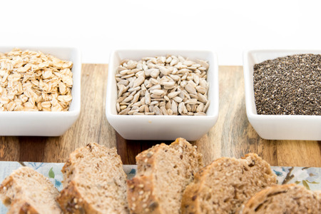 a fresh baked loaf of whole grains bread with poppy, flax adn sunflower seedsの写真素材