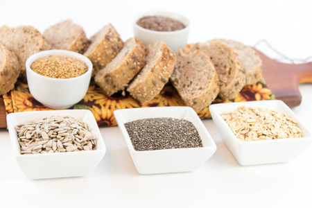 a fresh baked loaf of whole grains bread with poppy, flax adn sunflower seedsの写真素材