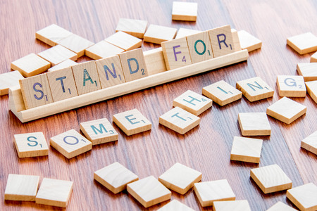 April 4, 2015:  Houston, TX, USA - Scrabble Word Game wood tiles spelling Stand For Somethingのeditorial素材