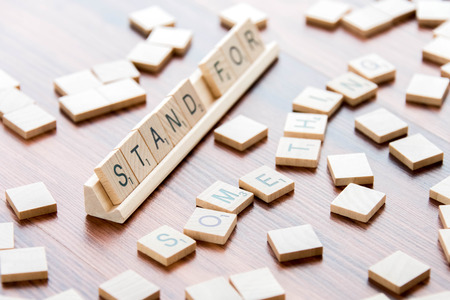April 4, 2015:  Houston, TX, USA - Scrabble Word Game wood tiles spelling Stand For Somethingのeditorial素材