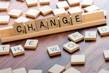 April 4, 2015:  Houston, TX, USA - Scrabble Word Game wood tiles spelling CHANGE THE WORLDのeditorial素材