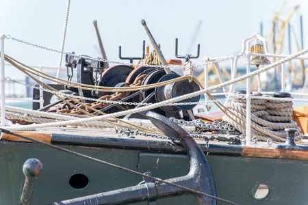 masts, rigging and rolled up sails of a tall sailboat