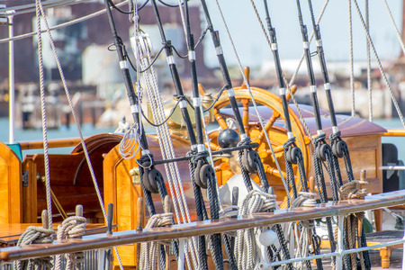 masts, rigging and rolled up sails of a tall sailboat