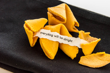 open fortune cookie with strip of white paper - EVERYTHING WILL BE ALRIGHTの写真素材