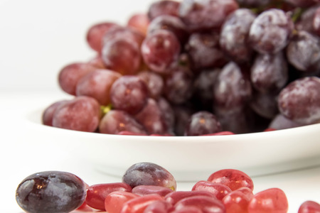 purple grapes vs purple jelly beans - snack decision between healthy food or junk food