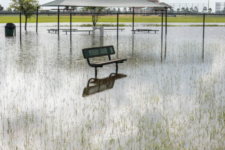 Standing flood waters covering fields and trailsの写真素材